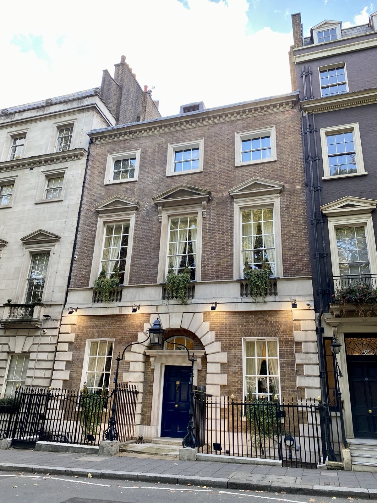 A Georgian brick townhouse with stone-dressed sash windows on Berkeley Square in Mayfair, London