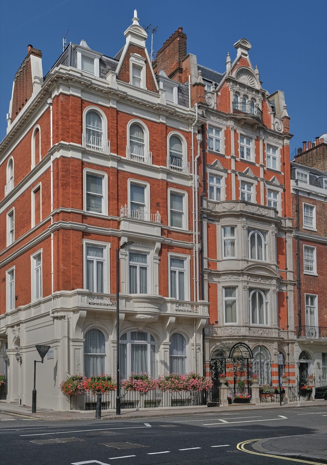 A red-brick period building on a Mayfair street corner in W1, London