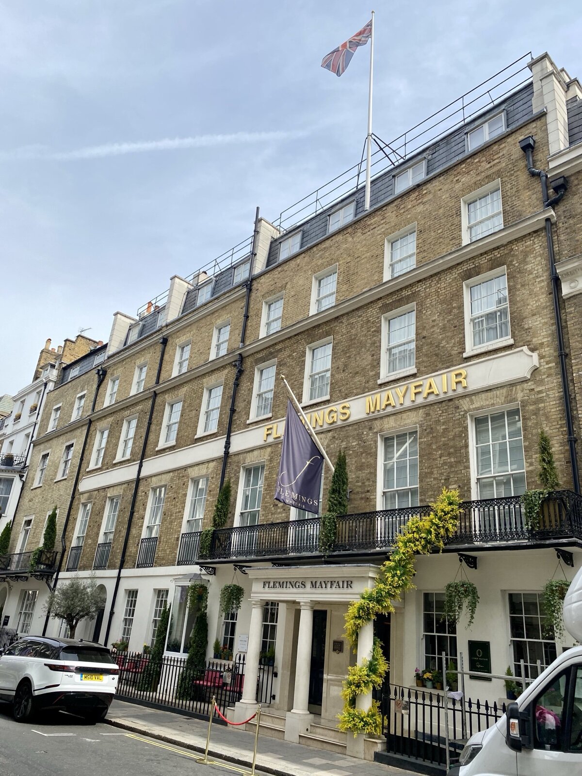 A Georgian townhouse hotel on Half Moon Street in Mayfair, with a portico entrance, iron railings and a Union flag