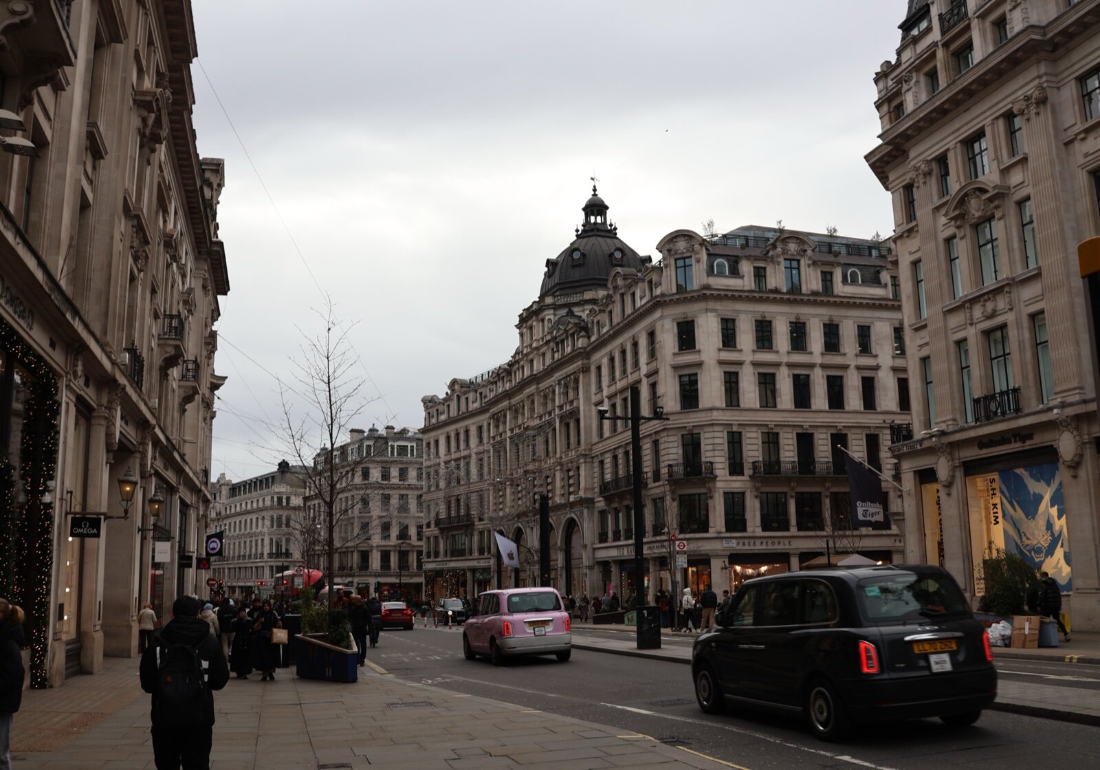 Regent Street in London looking north towards the curve of the Quadrant, with taxis and Portland stone facades