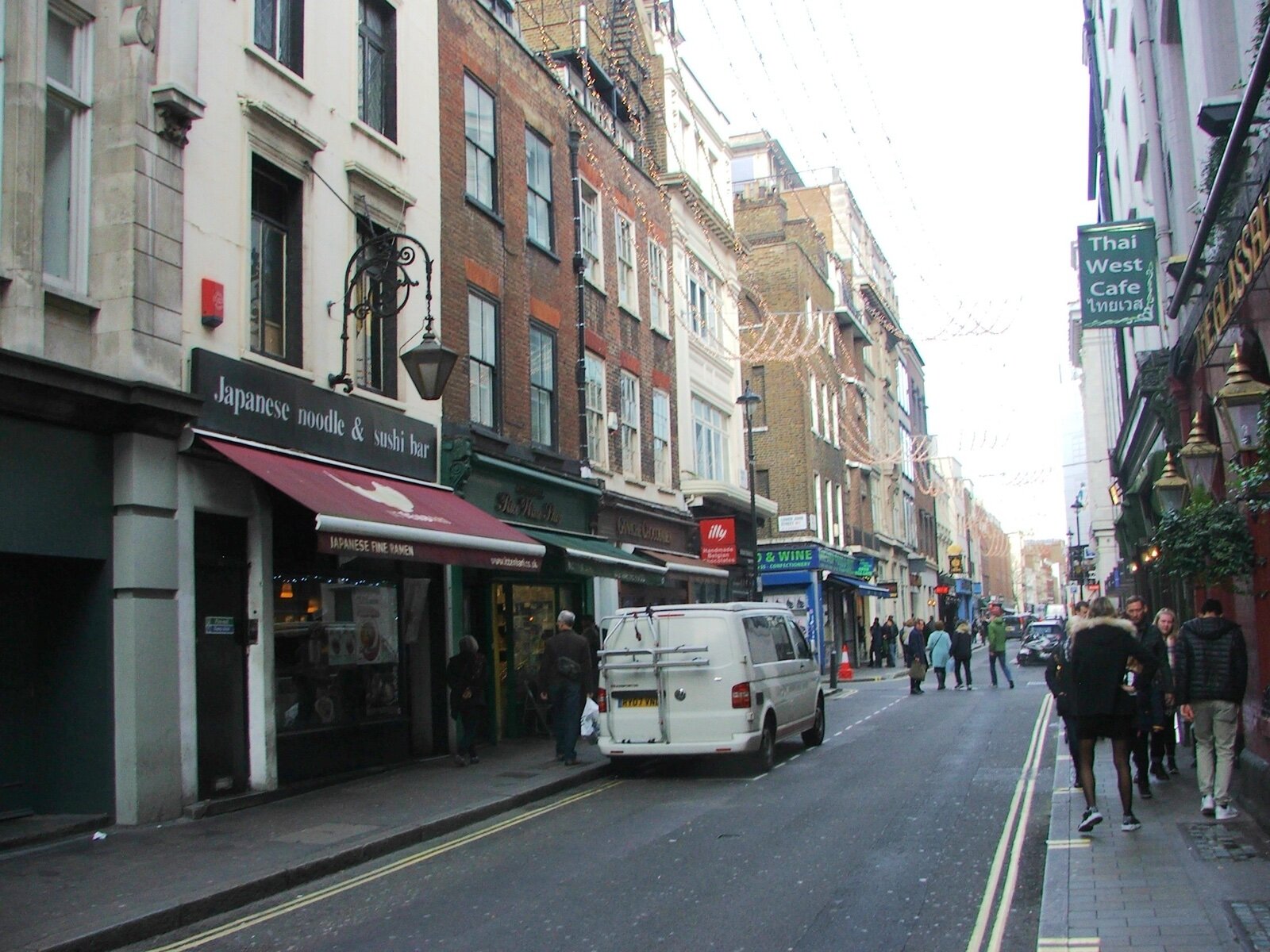 Restaurants and shopfronts along Brewer Street in Soho, central London