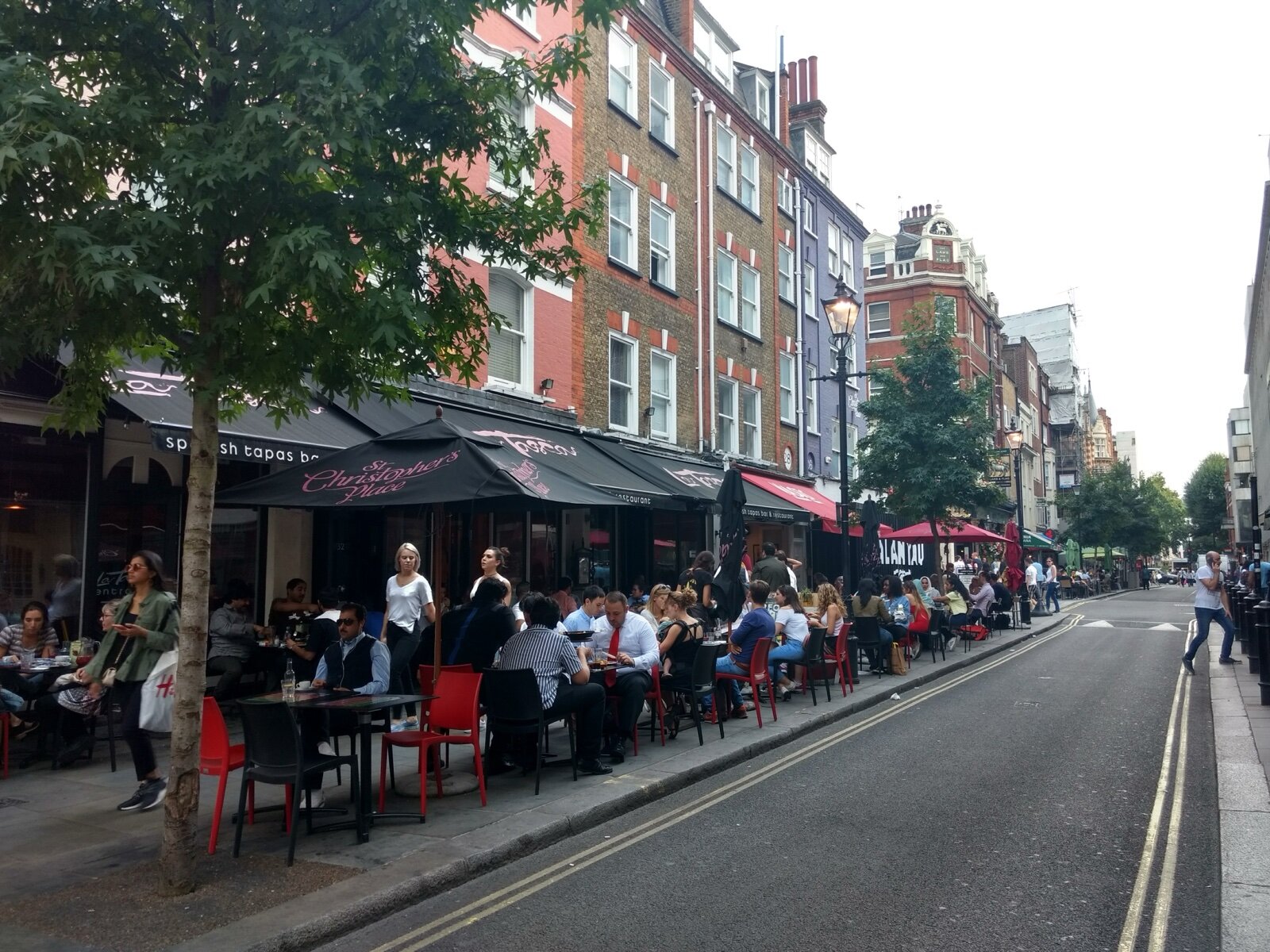 Diners at pavement tables outside restaurants on James Street in Marylebone